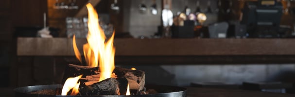 Picture of a fireplace at Stabben with a bar in the background