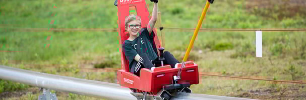 Boy is pulled up the elevator on a Mountain Coaster