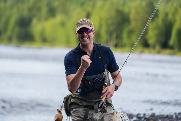 Man with fly fishing rod in the river