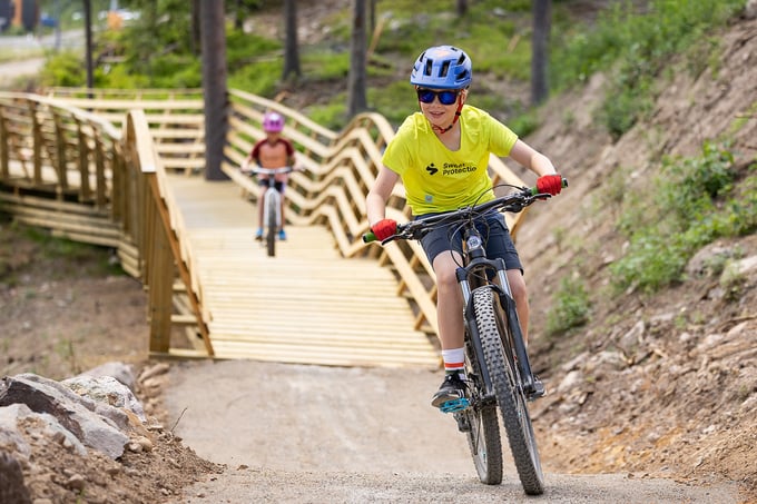 Boys whizzing down the path on bikes