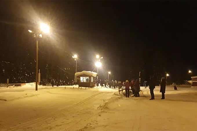 Many people in the floodlit trail in the evening