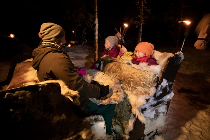 Family on a horseback sleigh ride in the evening