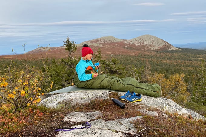Girl sitting in a mountain cloth in the mountains in the autumn
