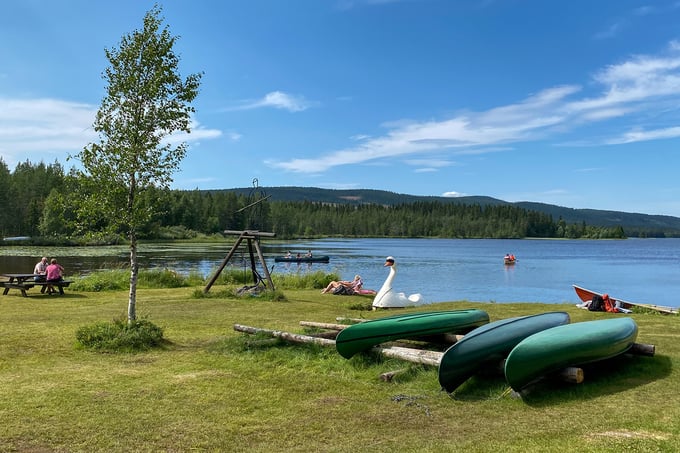 Swimming area with canoes located down by the water