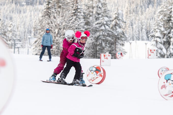Two girls slalom in the children's area Adventure